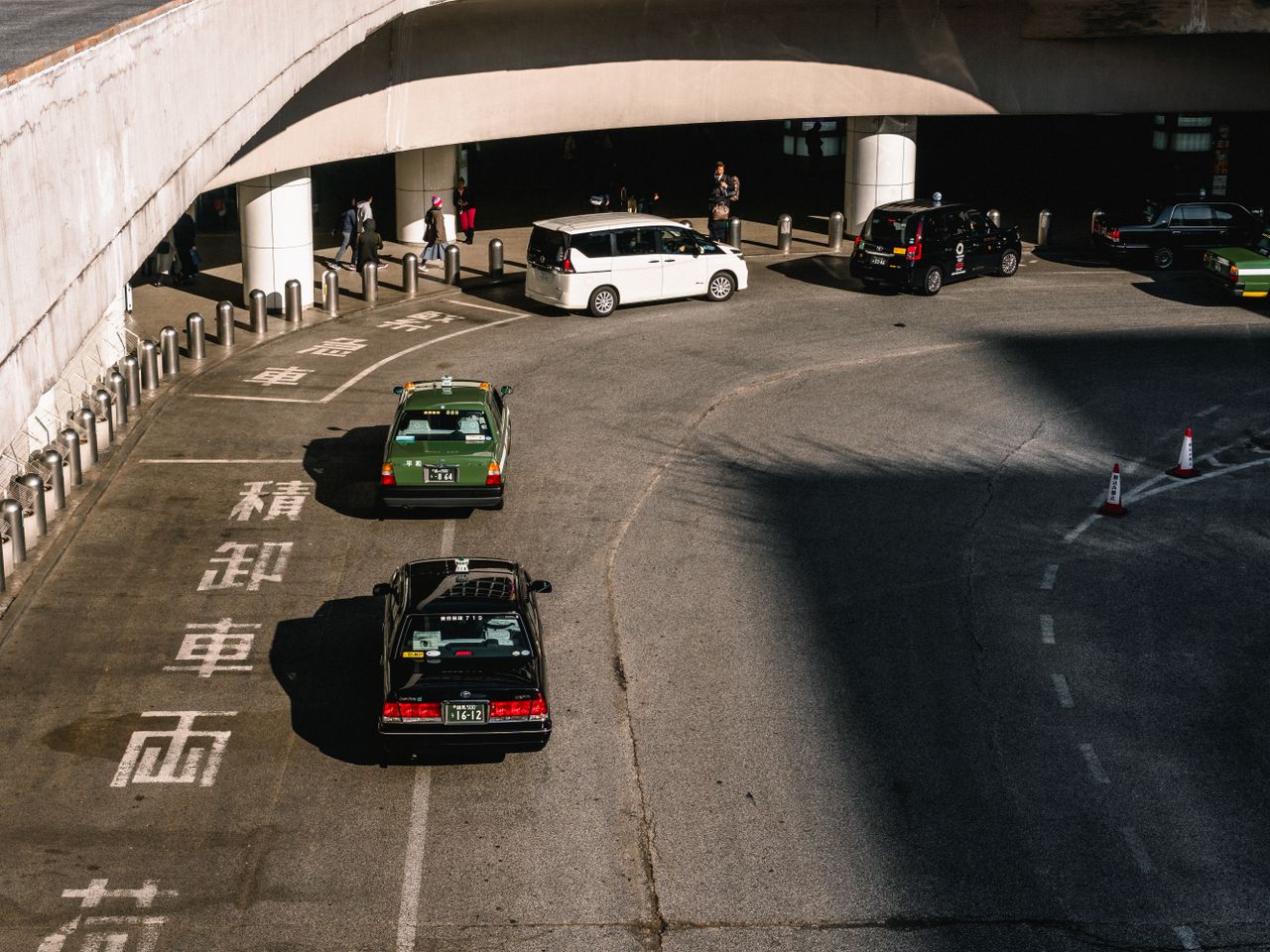 Crafting Captivating Headlines: Your awesome post title goes here A bustling urban intersection with taxis and cars moving under an overpass in daylight.
